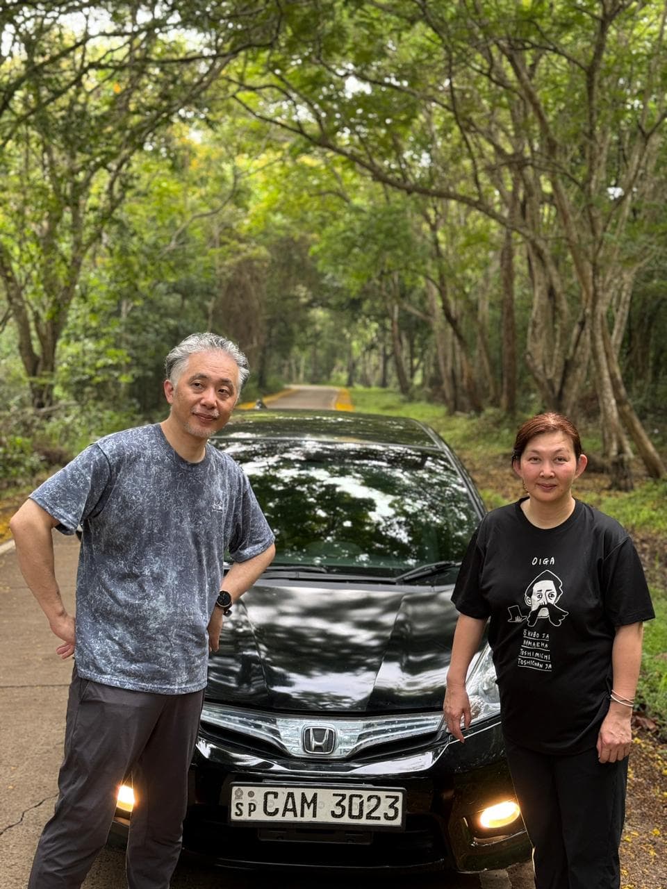 Travellers on a shaded forest road during a private driving day